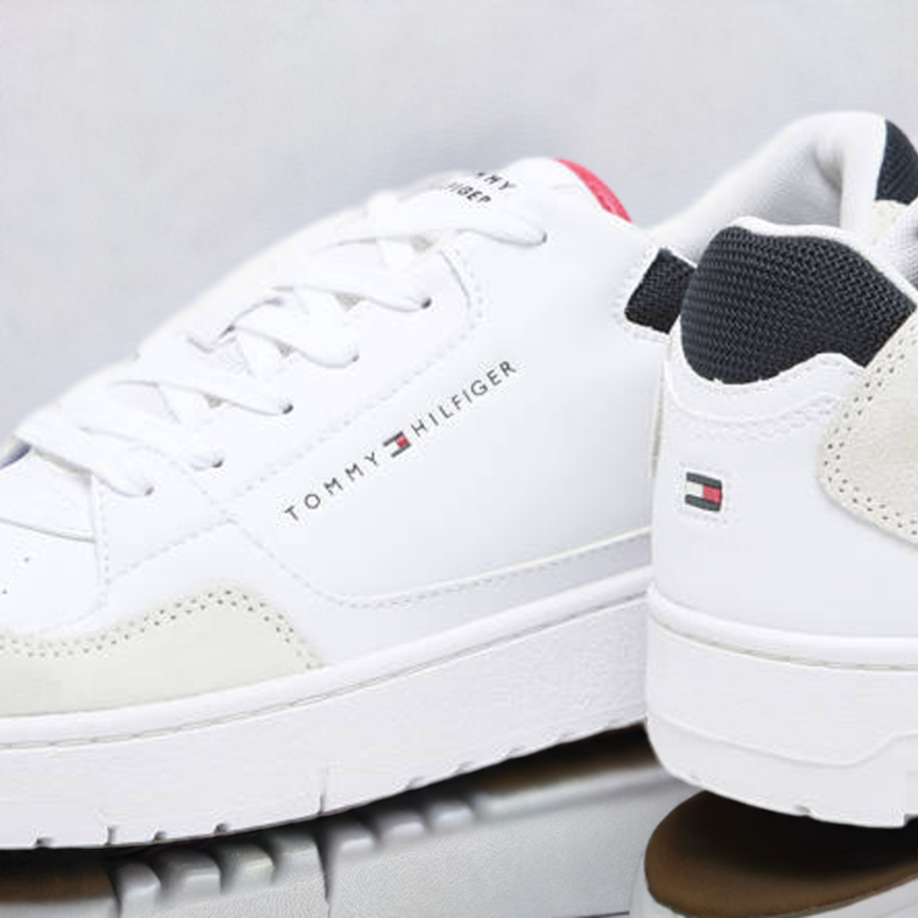 Close up of White Tommy Hilfiger Sneakers featuring red and navy blue accents, showcasing sleek design and logo details